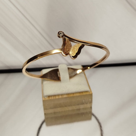 Gold armring on a white stand with a white background