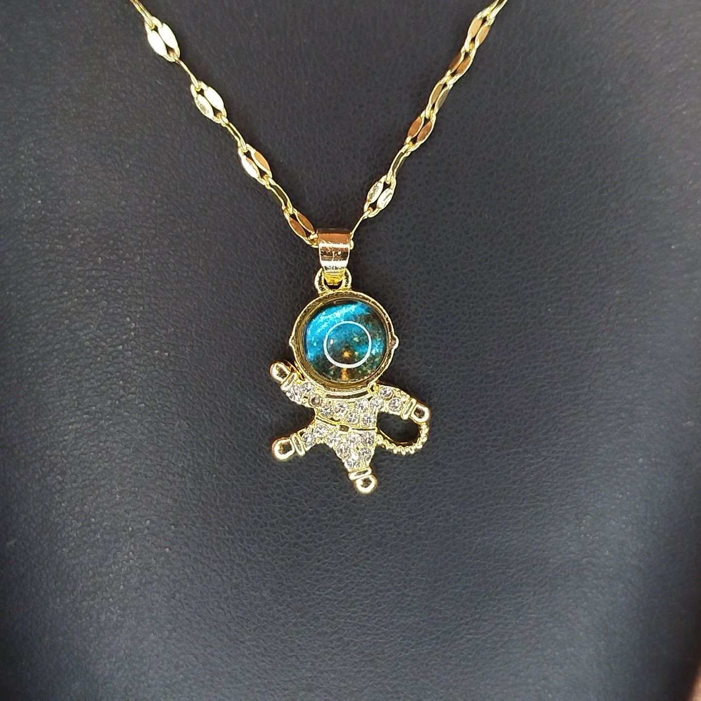 Gold necklace with a blue gemstone pendant