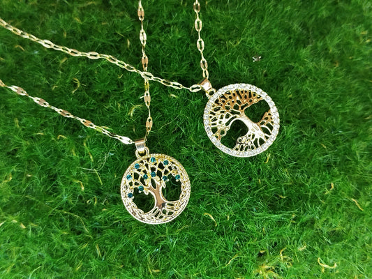 Tree of Life necklace with gold and silver elements on a green textured background