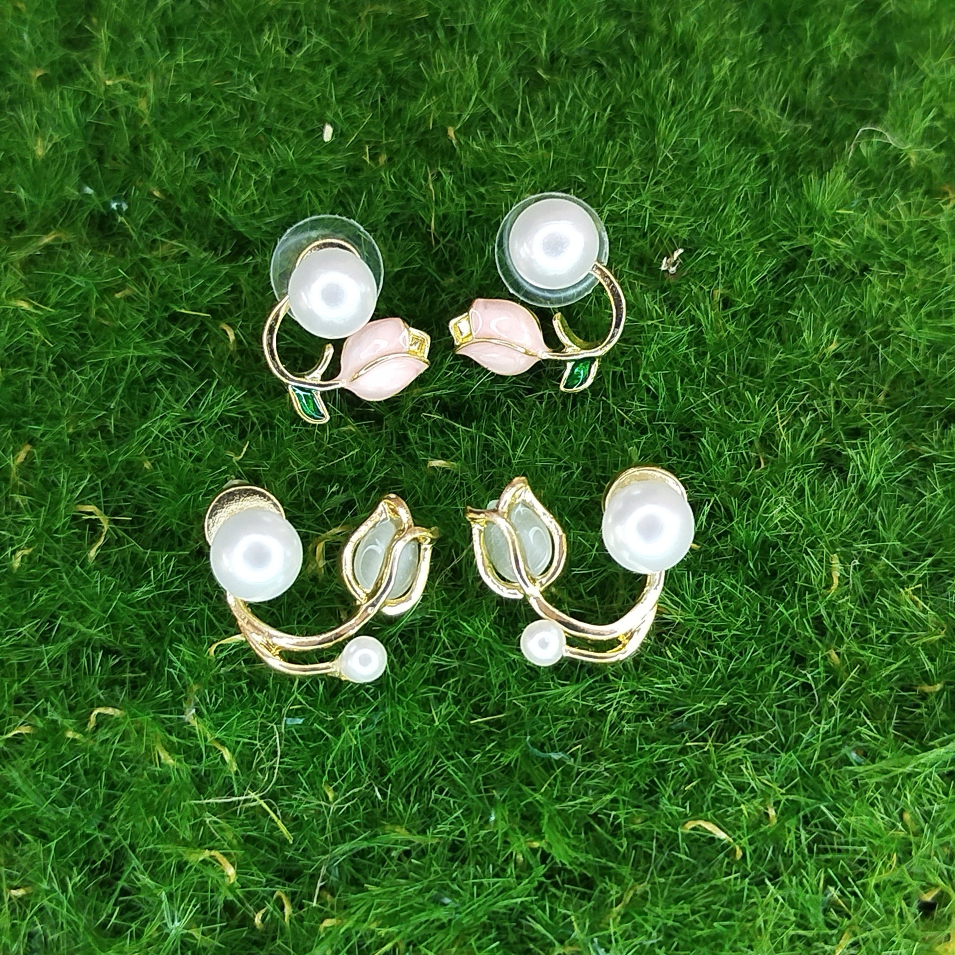 Set of earrings on a green grass background