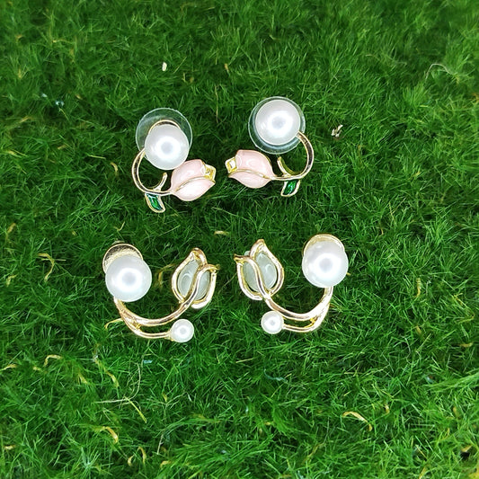 Set of earrings on a green grass background
