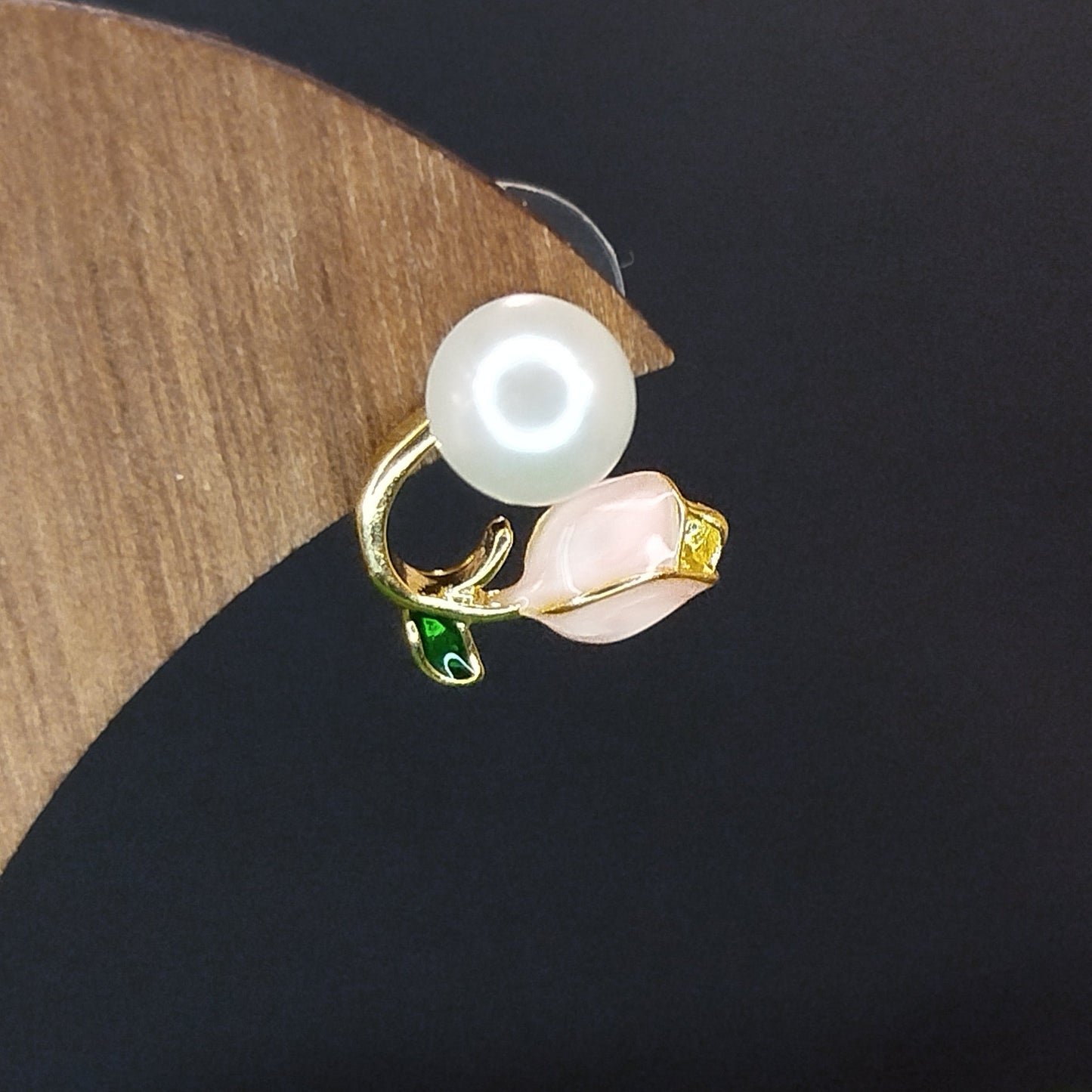 Pearl earring on a wooden stand