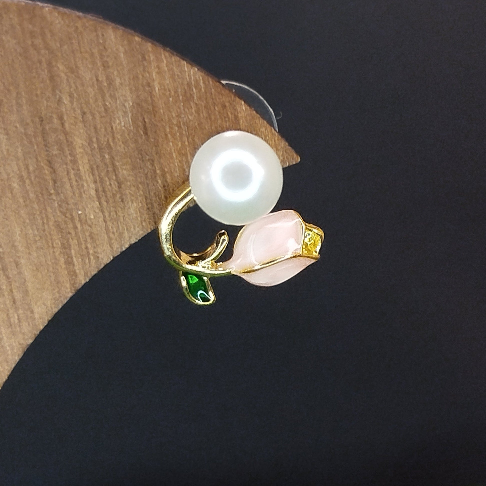 Pearl earring on a wooden stand