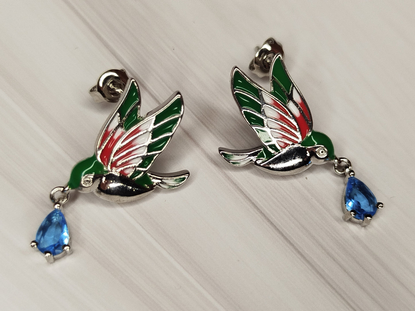 Bird-shaped earrings with blue teardrop stones