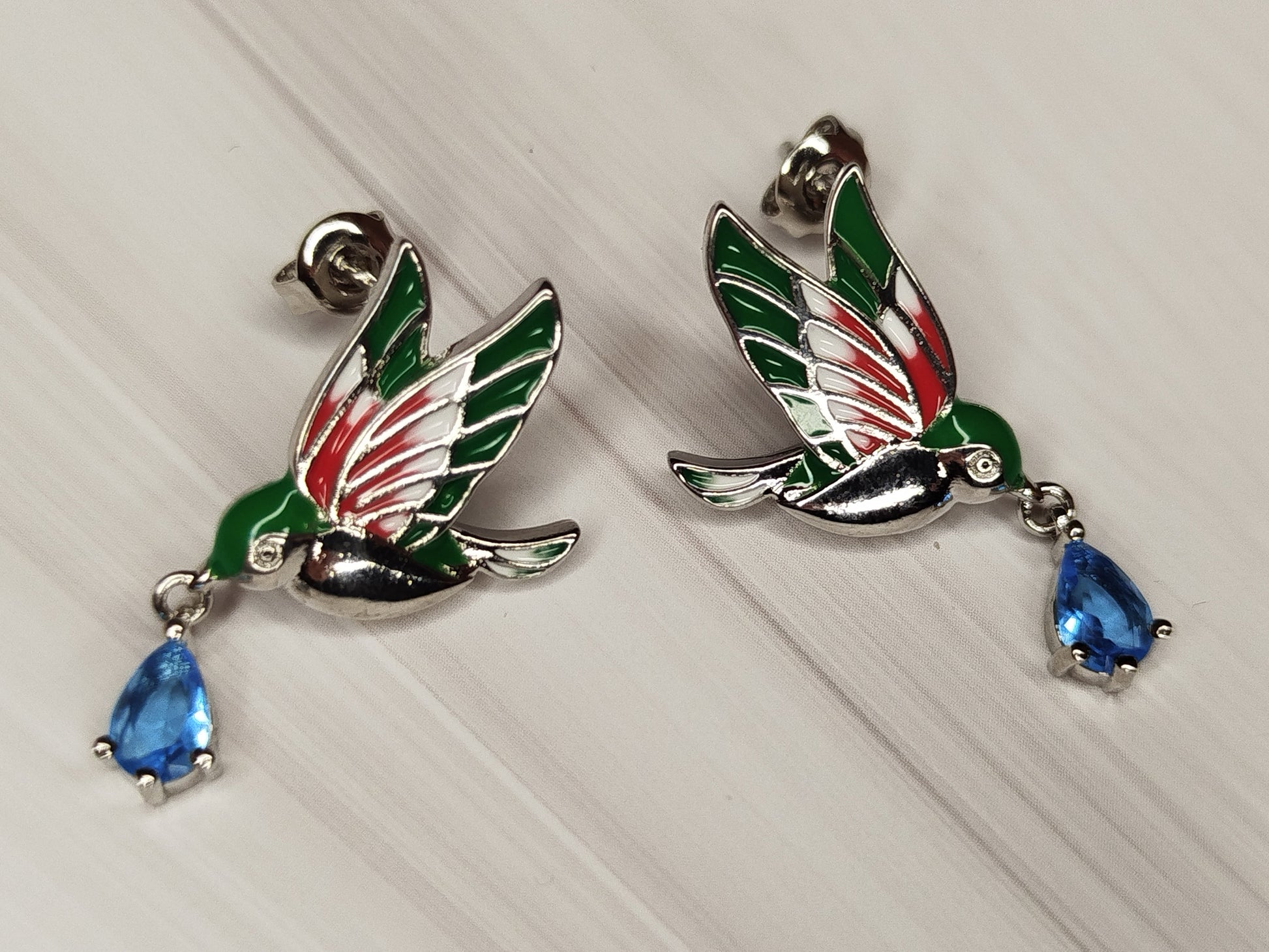 Bird-shaped earrings with blue teardrop stones
