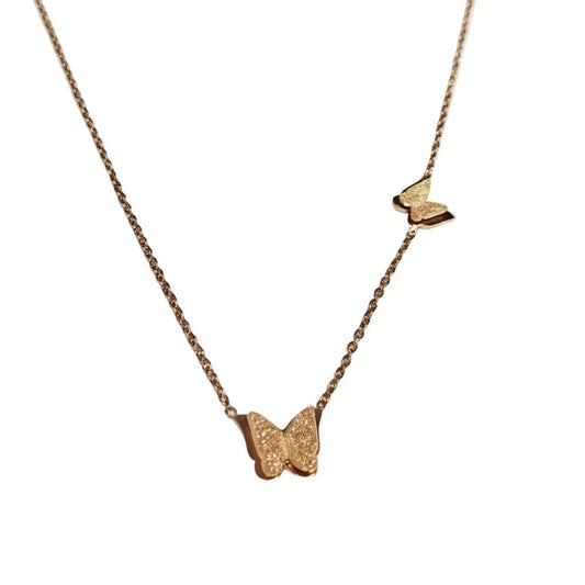Gold butterfly necklace on a white background