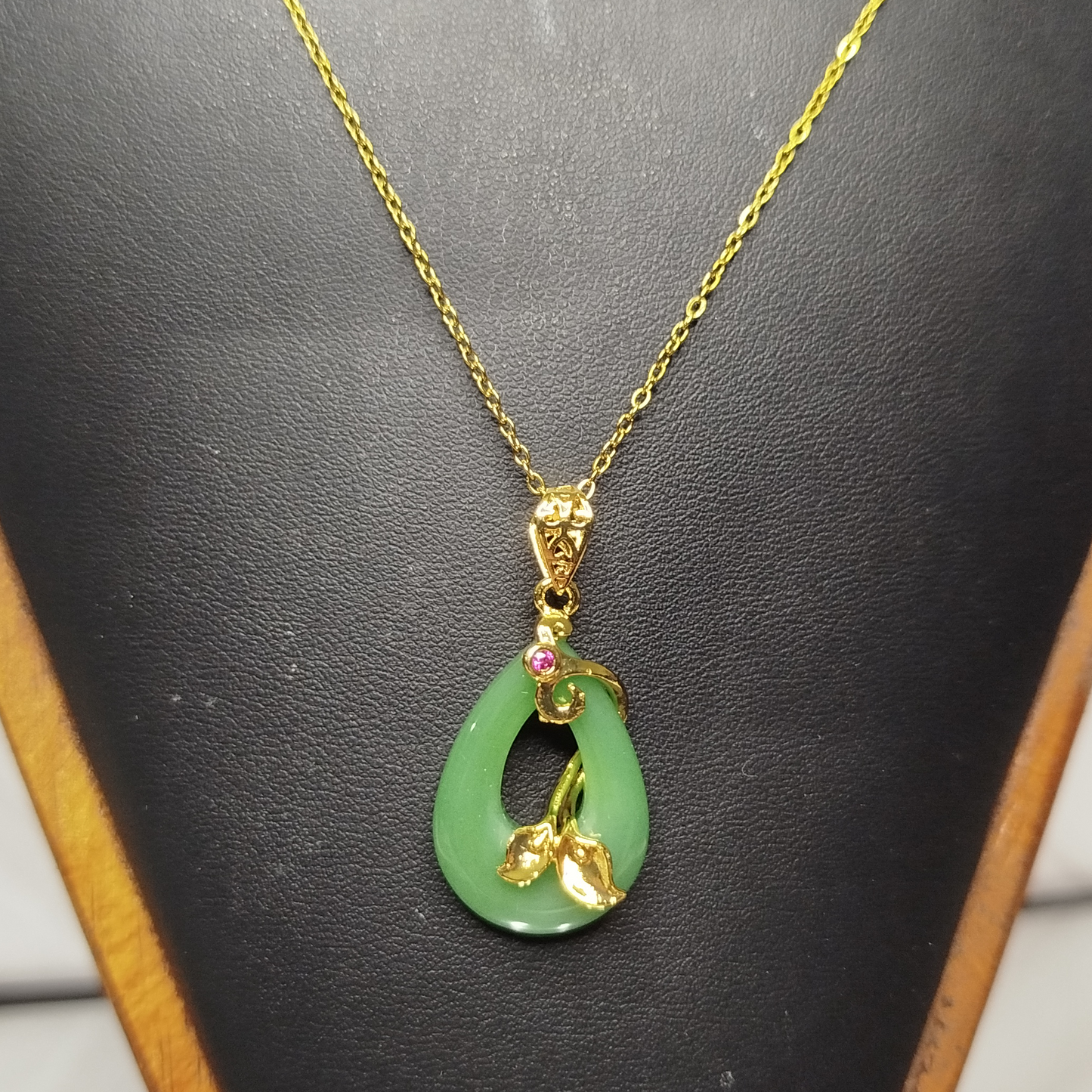 Gold necklace with a green pendant
